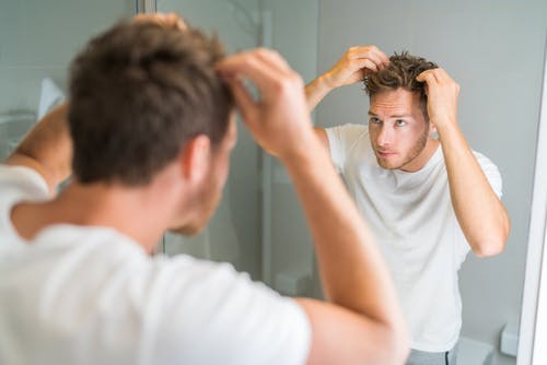 man checking hair growth