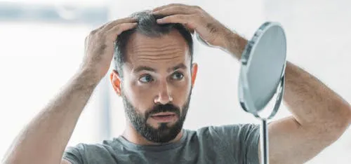 Man looking at his hairline